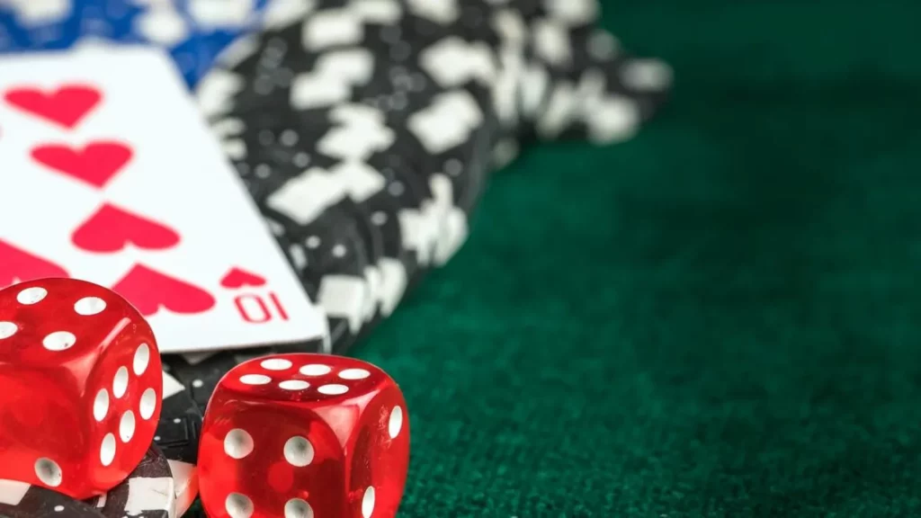 Image of a dice, cards and poker chips